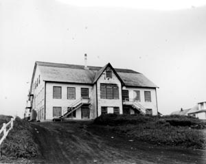 Photo of St. Paul schoolhouse, a multi-storied white building.